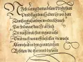 Text i gammal skrivstil från 1900-talet på gulnat papper. Texten är en dikt eller berättelse med dekorativa initialer och snirkliga tecken.