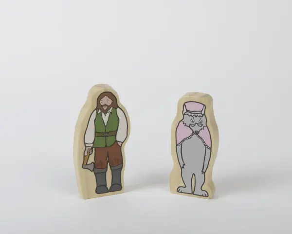 Två träfigurer: en man med yxa, klädd som en skogshuggare, och en varg i hatt och cape. Kanske redo för ett äventyr med tjuvar och banditer.